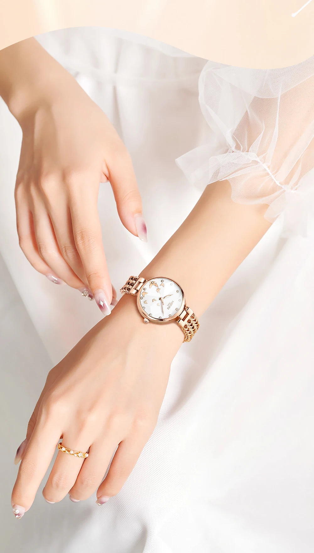 Rose gold watch on a wrist with a white background