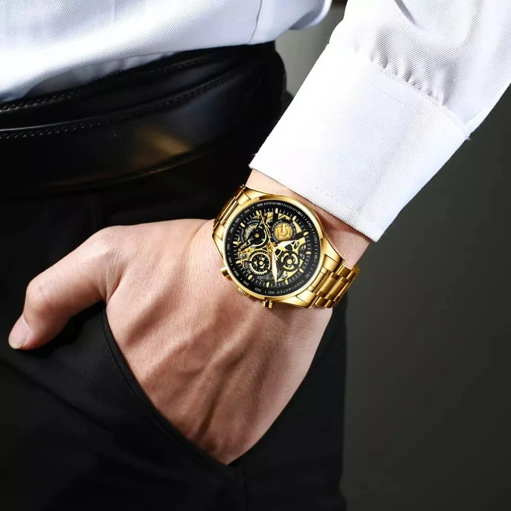 Gold wristwatch with black face on a person's wrist against a dark background