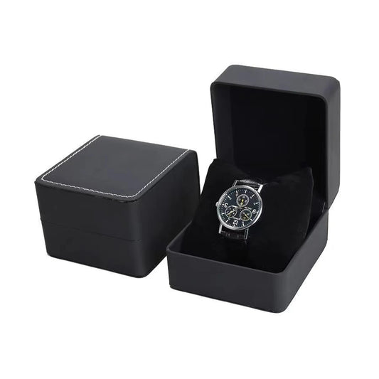 Black watch box with a silver watch inside on a white background