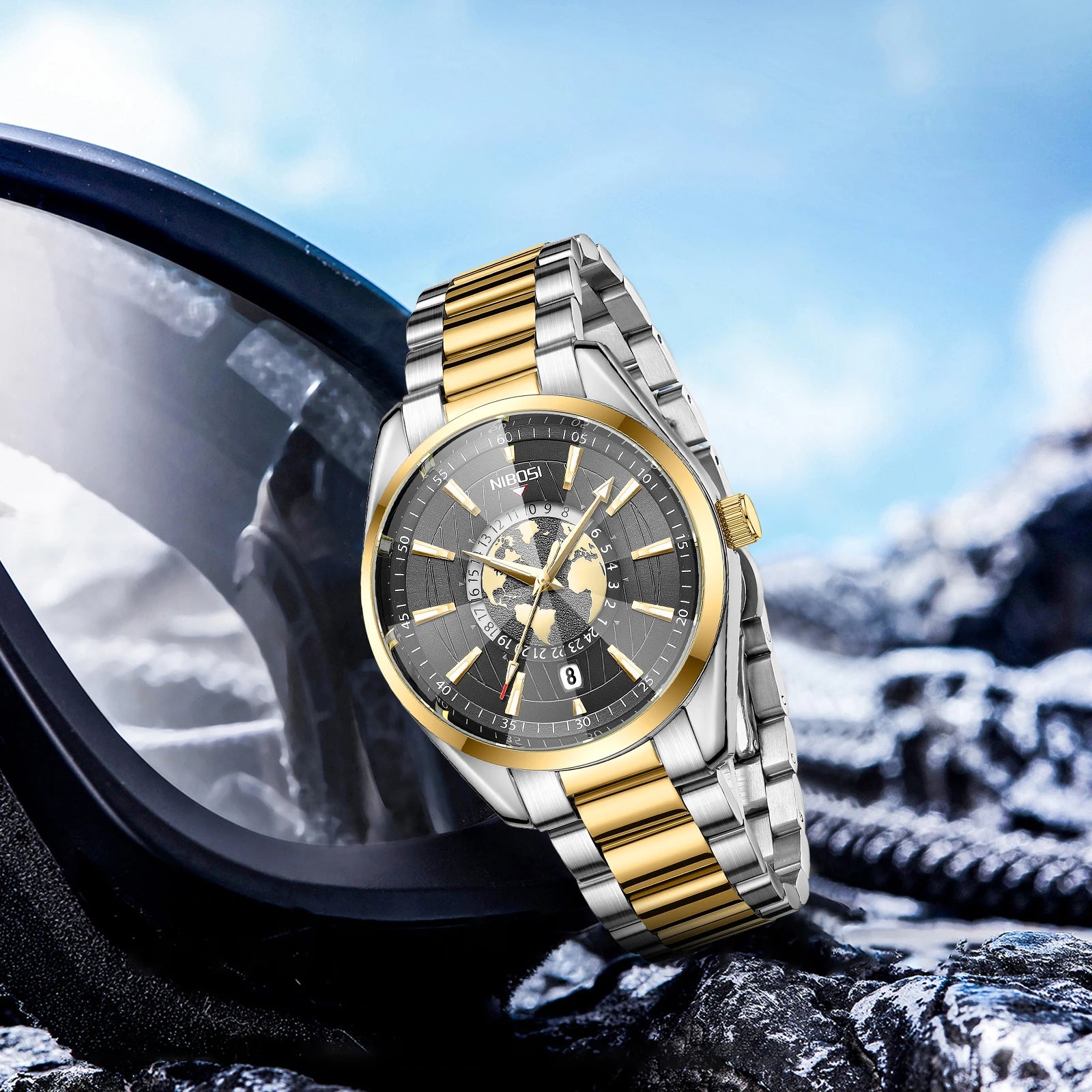 Gold and silver watch on a mountain background