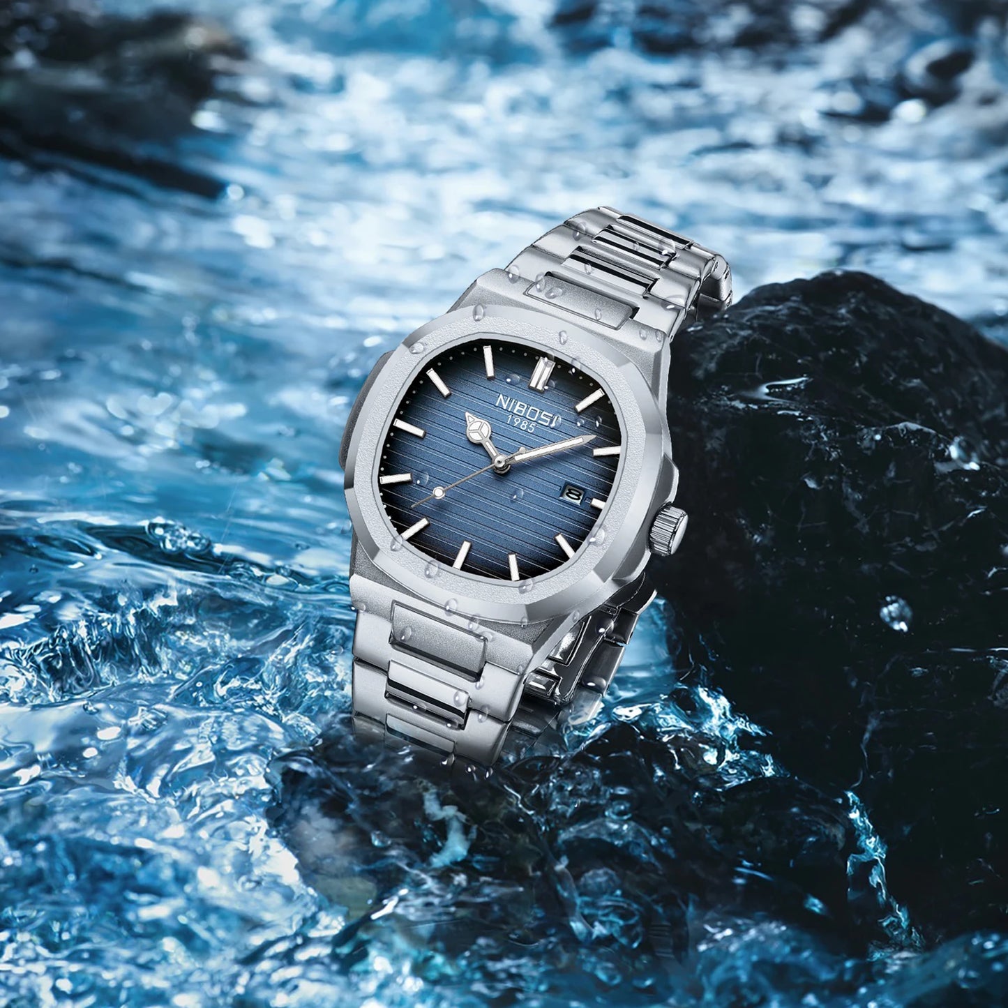 Silver watch with blue face on a rock with water in the background