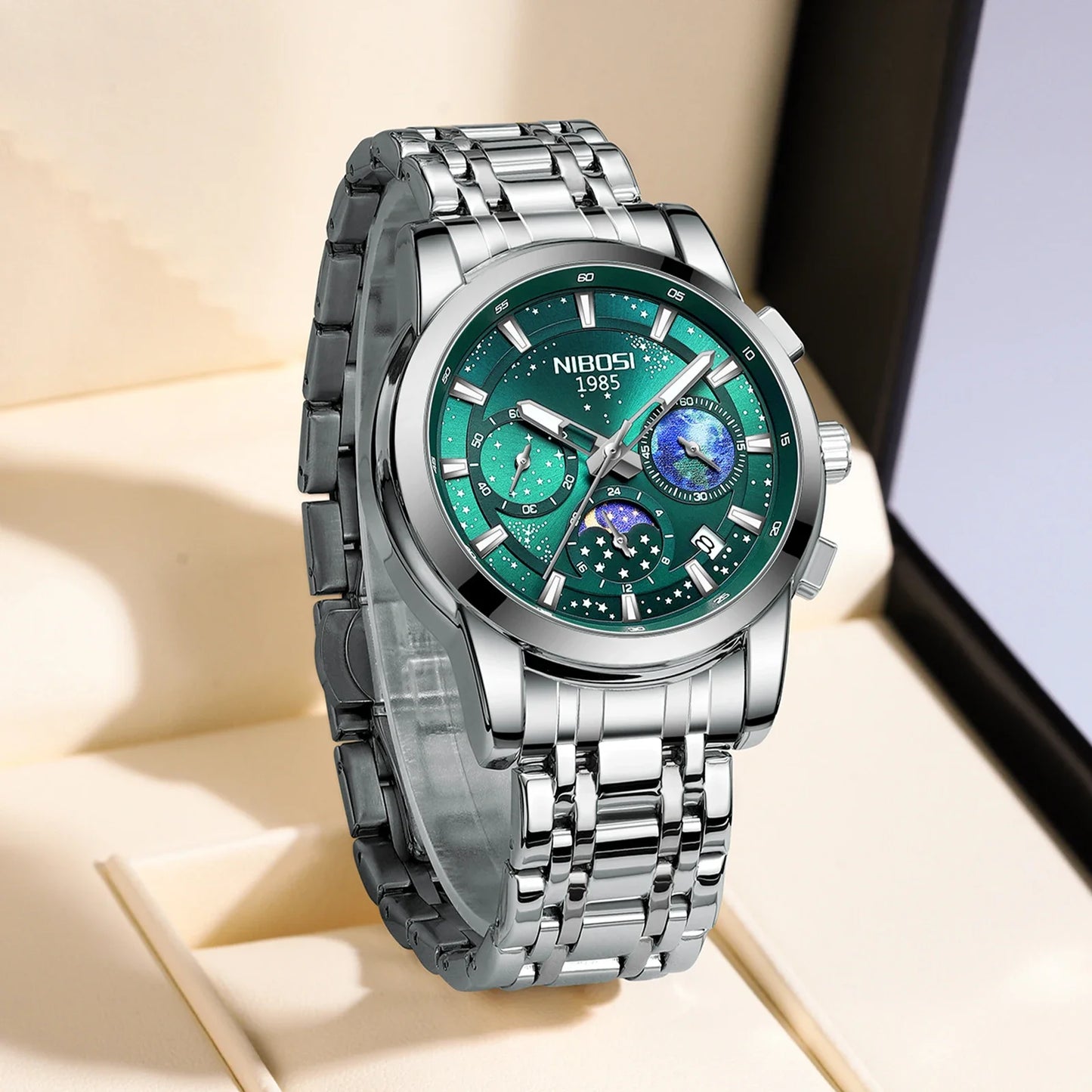 Silver wristwatch with a green face on a beige surface