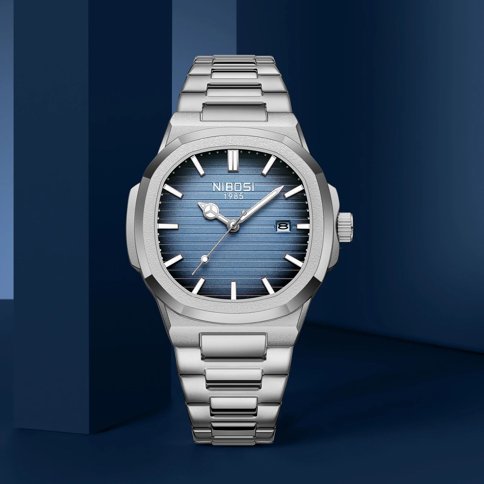 Silver watch with blue face on a dark blue background