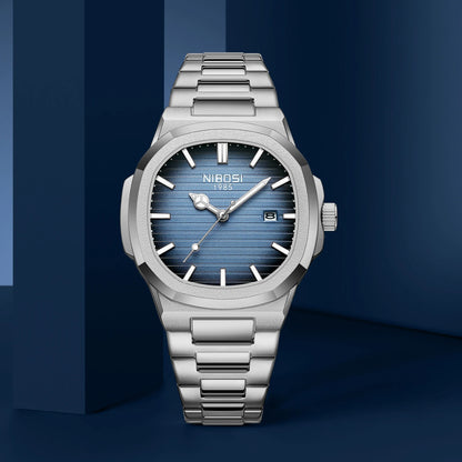 Silver watch with blue face on a dark blue background