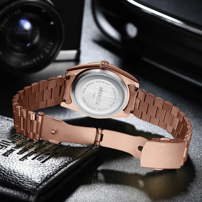 Rose gold watch with a detailed face on a textured surface