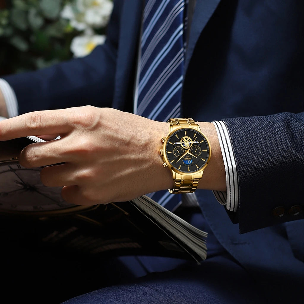 Gold wristwatch on a person wearing a suit with a blurred background