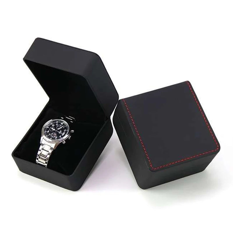 Black watch box with a silver watch inside on a white background