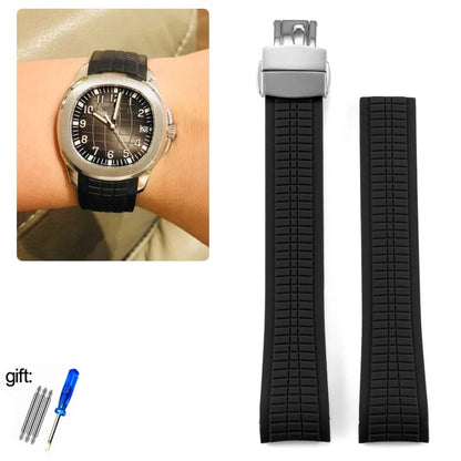 Black watch strap with metal clasp, worn on wrist, and additional straps and tools on white background