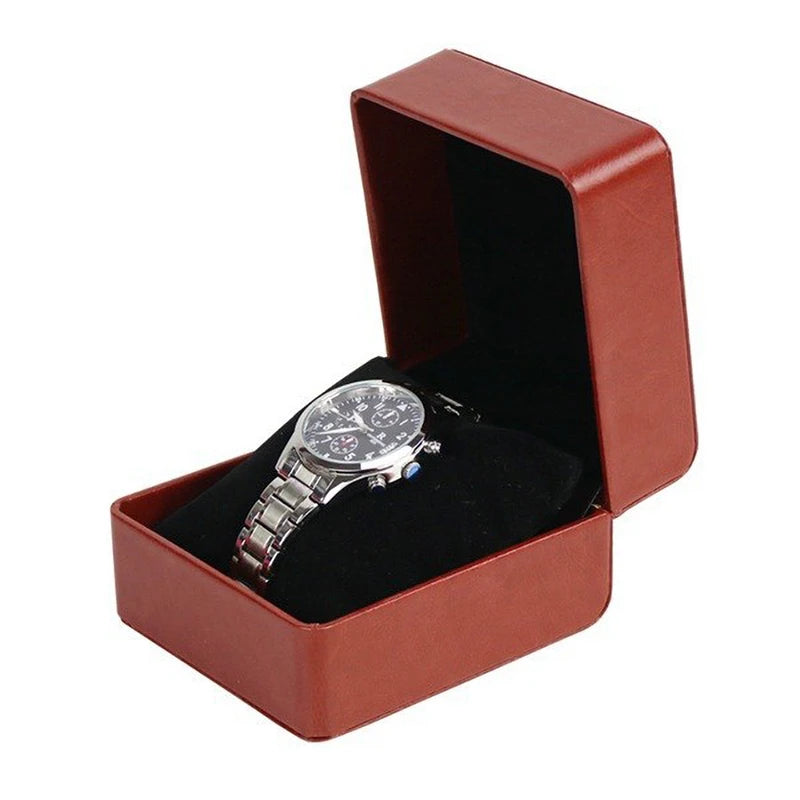 Silver watch in an open brown jewelry box on a white background