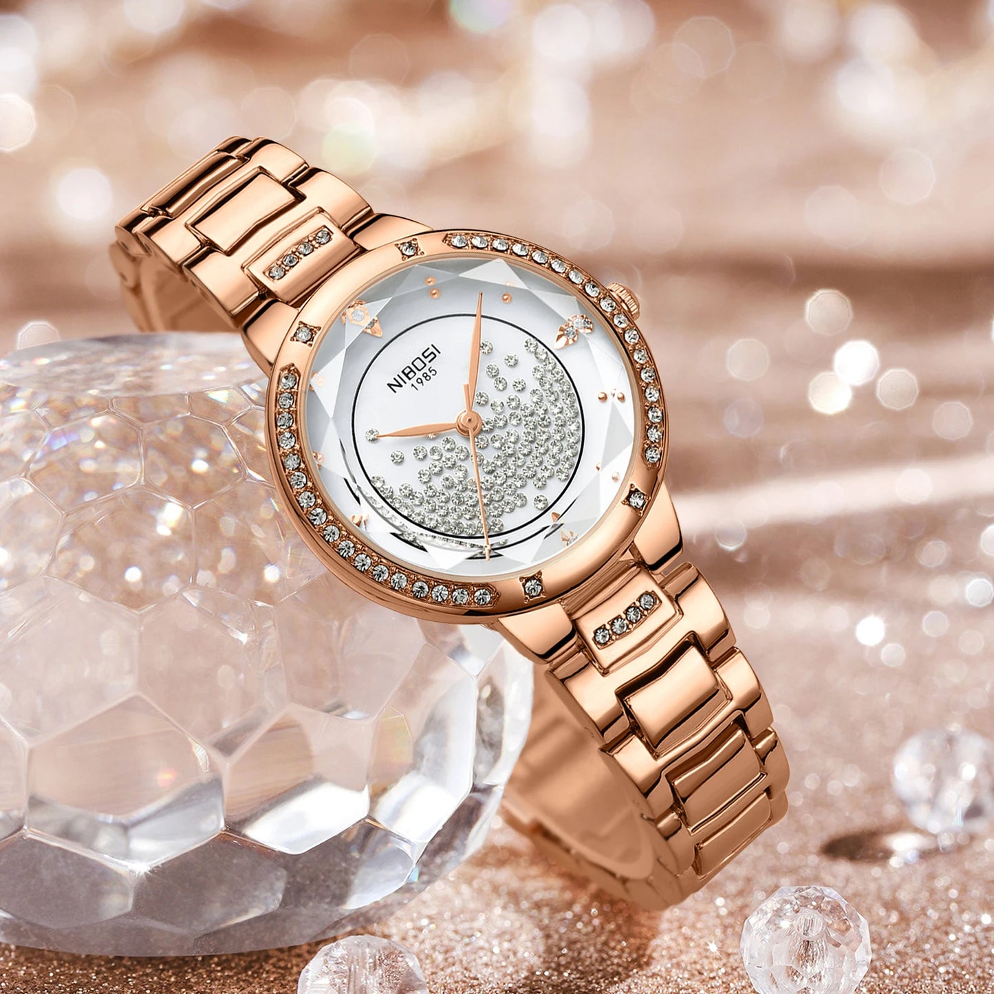 Rose gold watch with diamond accents on a sparkling background