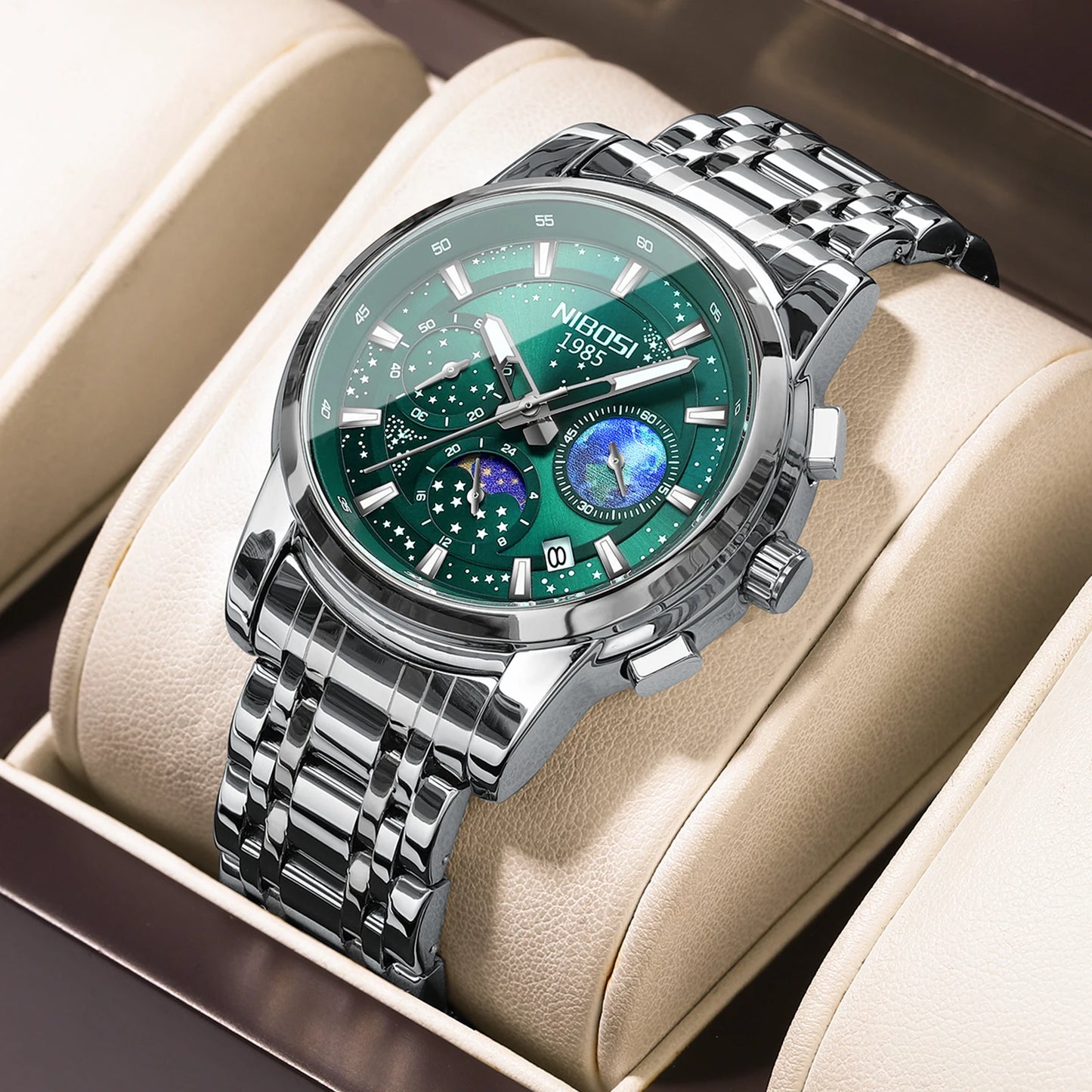 Silver watch with a green face in a beige display box