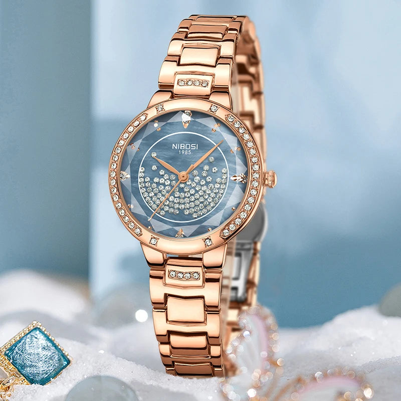 Rose gold watch with diamond accents on a light blue background