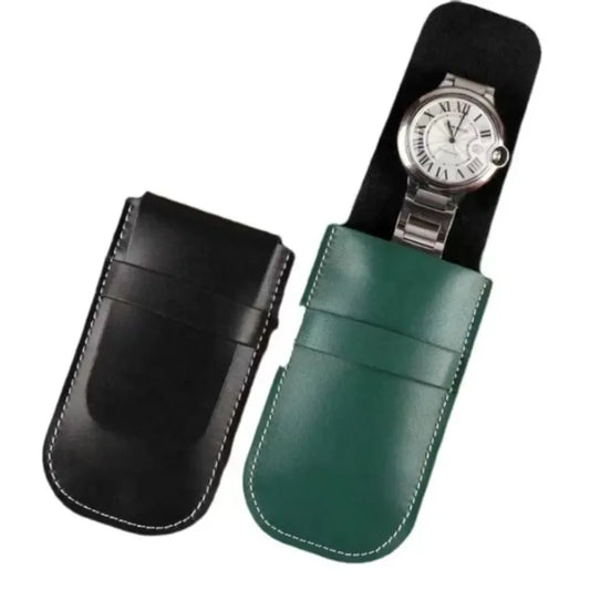 Green and black leather watch cases with a silver watch inside on a white background