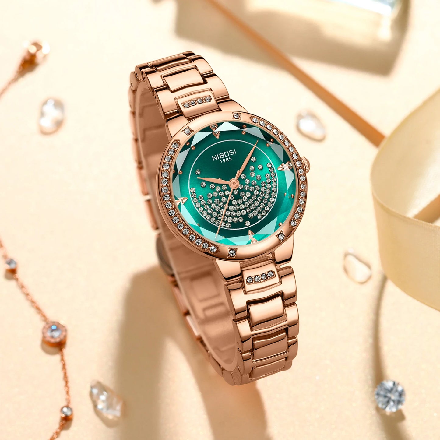 Rose gold watch with green face on a beige background