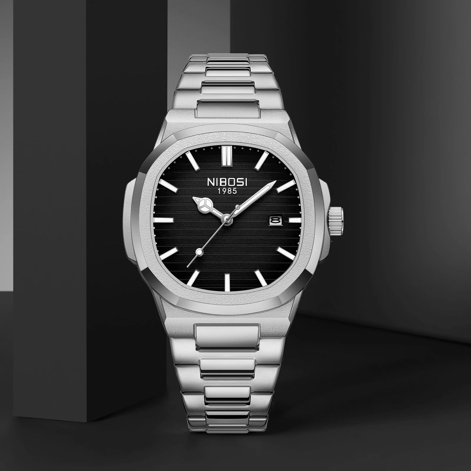 Silver wristwatch with black dial on a dark background