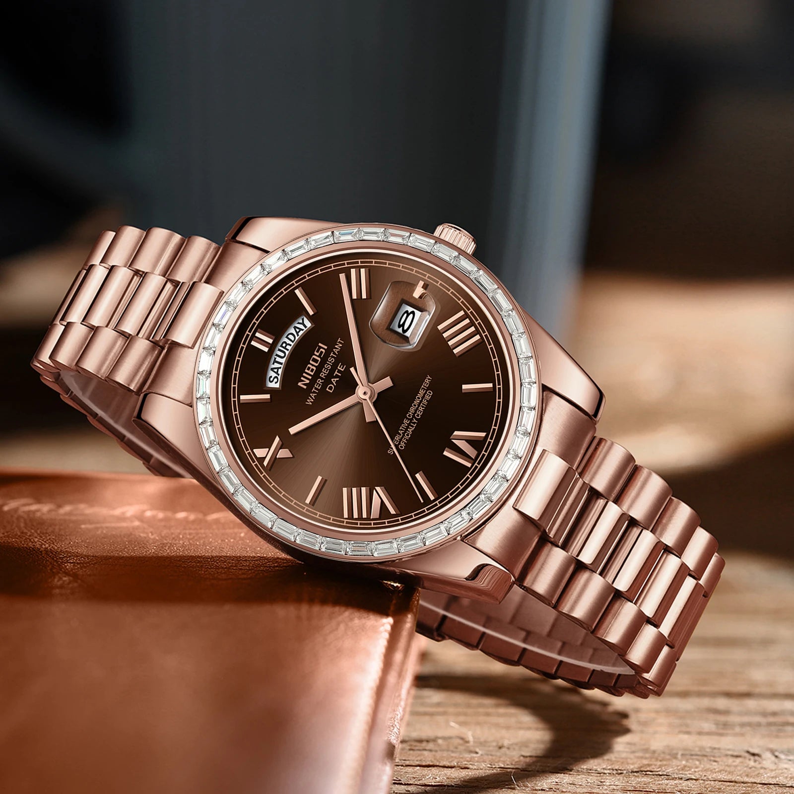 Rose gold watch with a brown dial on a wooden surface