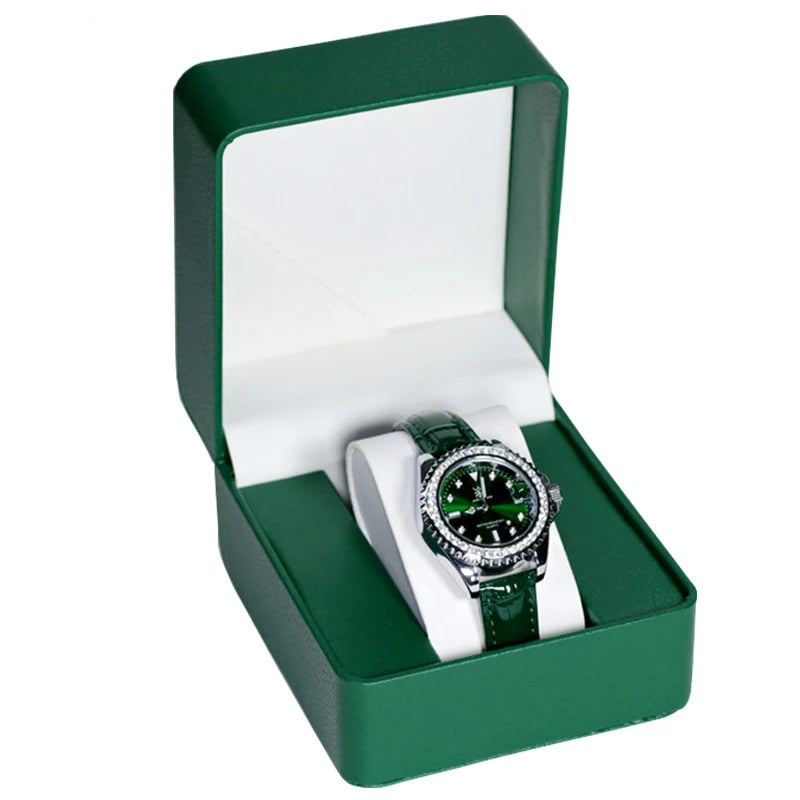 Watch with green strap and black face in a green box on a white background