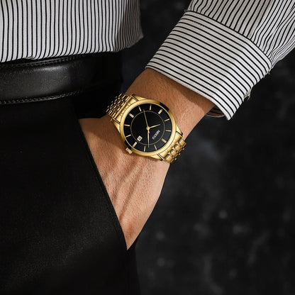 Gold wristwatch on a person's wrist with a blurred background