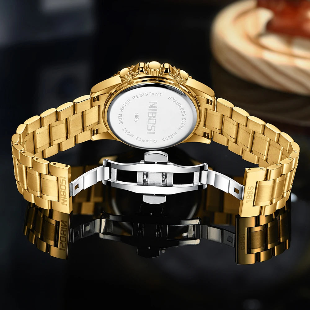Gold watch with a reflective surface on a dark background