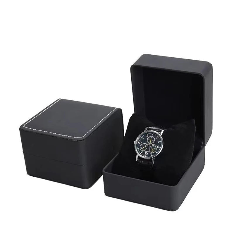 Black watch box with a silver watch inside on a white background