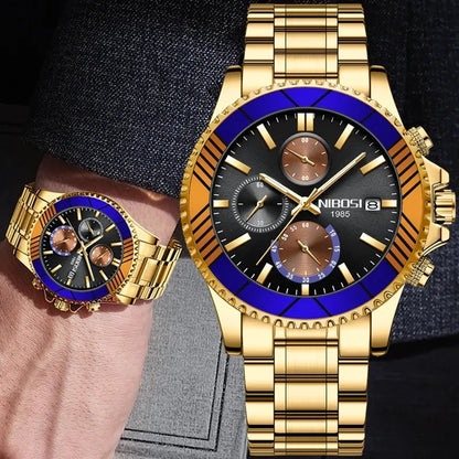 Gold wristwatch with blue accents on a hand against a dark background
